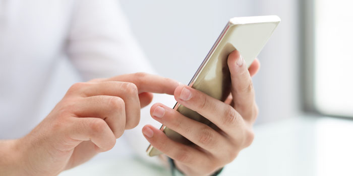 MOI Qatar Metrash Registration and User Guide (2025) Man Using Mobile Phone
