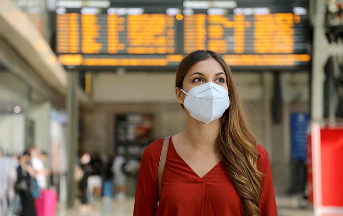 Traveller Woman At Airport Wearing Mask