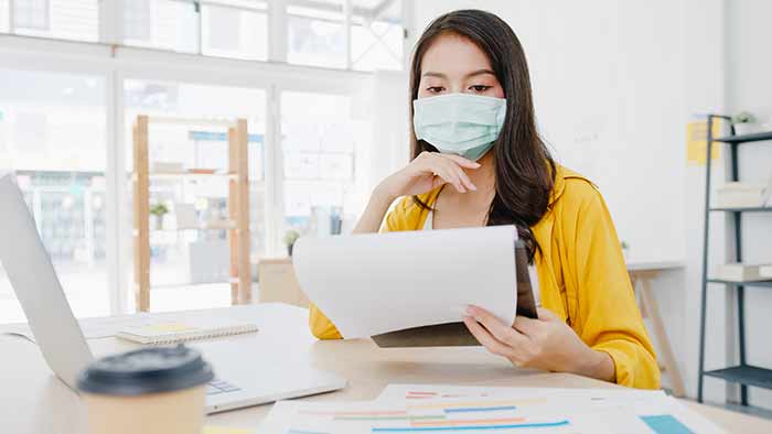 Woman Wearning Mask Using Laptop