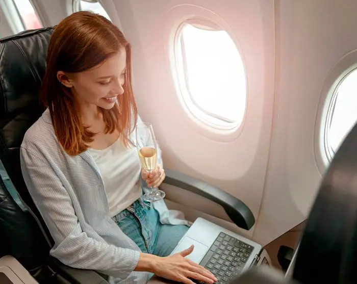 Traveller drinking alcohol in flight