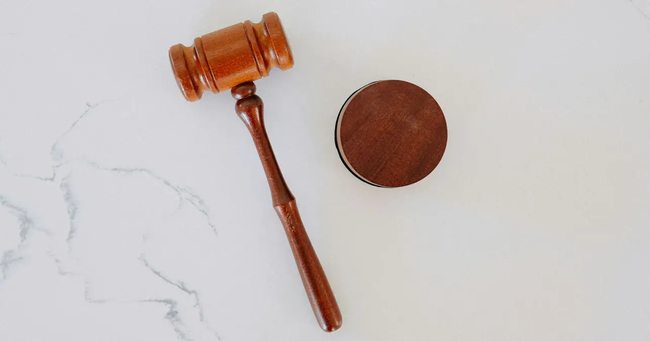 An image of a wooden gavel and its sounding block